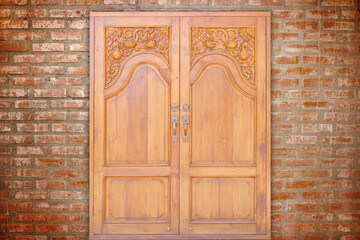 carving teak entrance wooden door on vintage wall