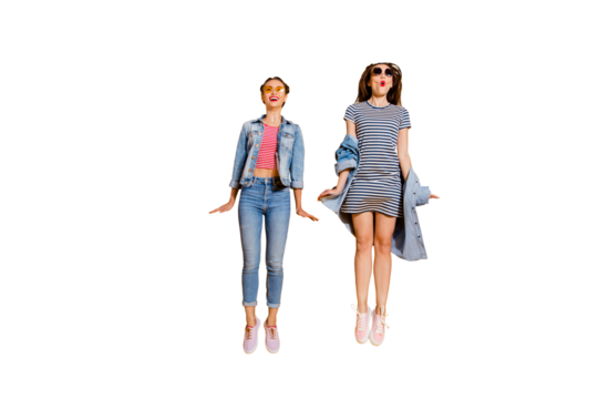 Full legs length body size two funny funky glad positive grinning cheerful charming friendly optimist lady in glasses spectacles casual denim jeans outfit jump isolated on yellow bright background