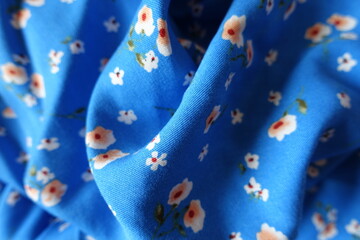 vibrant blue cotton fabric with old fashioned floral print in soft folds