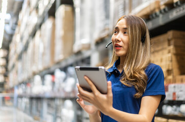 Fototapeta premium Female engineer is handling shipping and checking stock inventory in the warehouse with a tablet, industry, import-export, inventory management, logistics, global transportation at warehouse, business