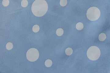 Surface of light blue rayon fabric with polka dot pattern