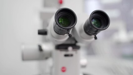 Close-up shot of microscope eyepiece tube in modern medical research laboratory. Modern equipment for scientists work in the genetics lab, biotechnology. Dental microscope in stomatology clinic. - Powered by Adobe