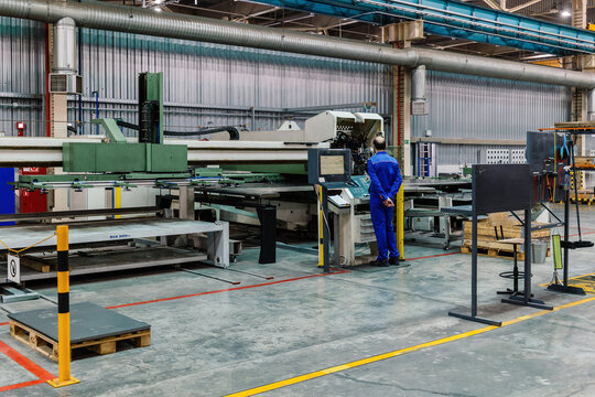 Engineer operates CNC perforation machine