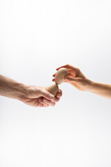 Hands tapping eggs. Easter. Unbreakable concept.