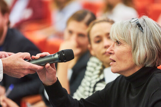 Audience answering during business conference in convention center