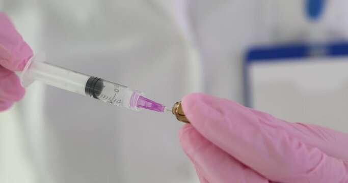 Nurse drawing medicine into syringe from ampoule in clinic closeup 4k movie slow motion. Intravenous and intramuscular administration of drugs concept