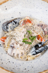 Close up pasta with seafood in delicate cream sauce top view