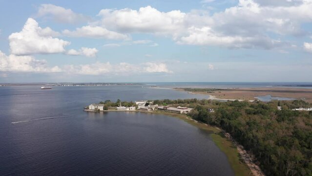 Aerial wide rising shot of Fort Johnson with Fort Sumter in the distance in Charleston Harbor, South Carolina. 4K