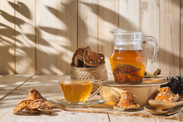 Bael Tea glass with dried bael slices on wooden background, juice perfect for detox and relaxation....