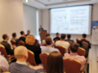 Blurred background image of audience in a business conference or seminar.