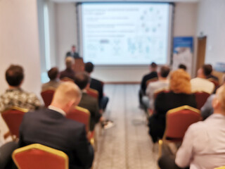 Blurred background image of audience in a business conference or seminar.
