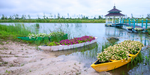 River Romance: Gazebo, Boat, and Bridge with Flowers - 773934764
