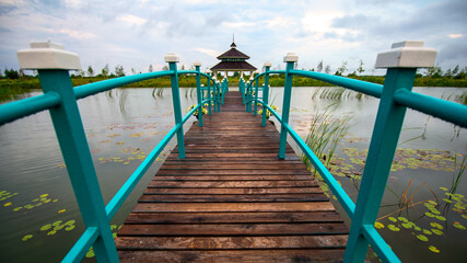 Tranquil Retreat: Gazebo Linked by Bridge Over Water - 773934768