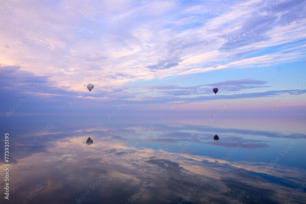 Wall mural Skyward Drift: Wind Ball Soars Above Water Against the Sky