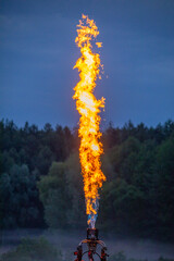 Celestial Bonfire: Gas Burner Flames Flicker in the Evening Sky - 773935155