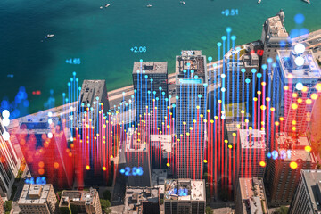 Aerial view of a city with virtual holographic financial data overlaying the skyline, digital and futuristic concept. Double exposure
