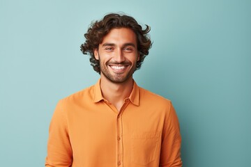 A man with a big smile is wearing an orange shirt - obrazy, fototapety, plakaty