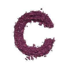 Stencil capital letter C made by burgundy crushed eye shadow or broken powder isolated on white background.