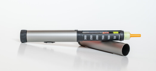 Insulin pen injector.  Insulin pen fill with needle on white background.