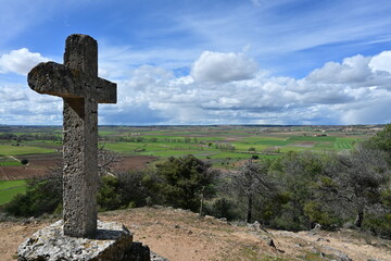 Fototapeta na wymiar Stone cross, via crucis, with landscape