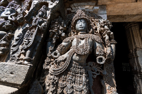 An ornate sculpture of a Dwarapala (gatekeeper) at the entrance to the ancient Hoysaleshwara temple complex in Halebidu in Karnataka.
