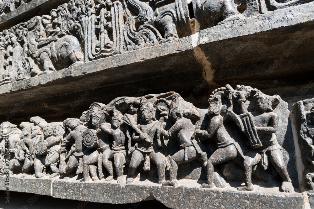 Wall mural Beautiful stone carvings on the walls of the ancient Hoysaleshwara temple in Halebidu in Karnataka.