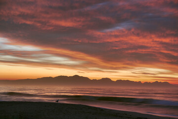 Beautiful Sunrise Morning Over Beach And Sea Looking Towards Mountains In South Africa