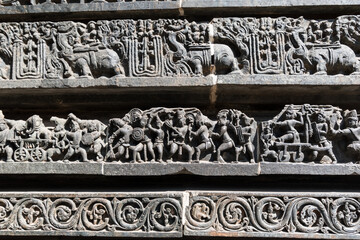 Beautiful stone carvings on the walls of the ancient Hoysaleshwara temple in Halebidu in Karnataka.