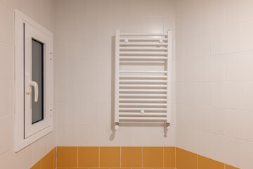 A Bathroom With Orange Tiles And A White Towel Rack