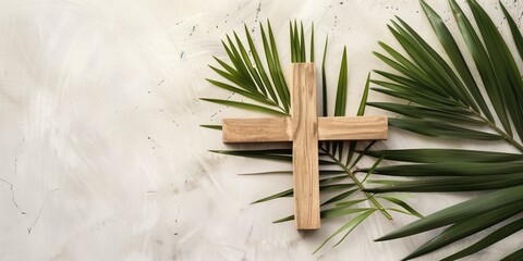 Palm Sunday background Wooden cross and palm leaves lying on neutral background with copy space for text. Christianity, faith, religious, Holy Week concept