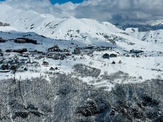Gudauri Village Panorama With Ski Resort Background From Aerial Perspective. Aerial drone view of...