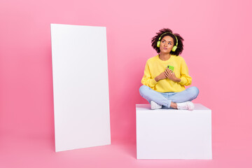 Full body photo of young lady dream look empty space sit platform use cellphone listen radio...