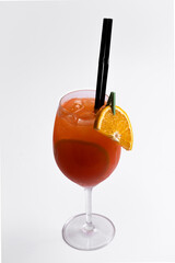 Cocktail with orange and straw on a white background.