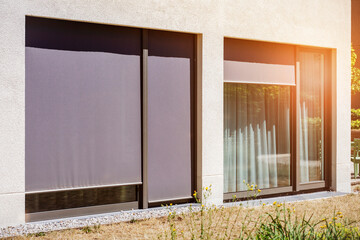Window Shutters or Roller Blinds Outside of Modern Facade House. External Shutters. Sun Protection Exterior House.	
