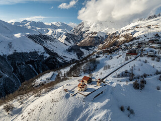 Aerial drone view of Gudauri ski resort in winter. Caucasus mountains in Georgia. Amaglebis eklesia...
