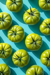 Fresh green tomatoes with green leaves on blue background Organic and vibrant vegetable concept