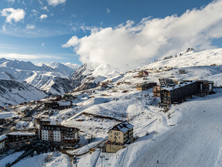 Gudauri Village Panorama With Ski Resort Background From Aerial Perspective. Aerial drone view of Gudauri ski resort in winter. Caucasus mountains in Georgia