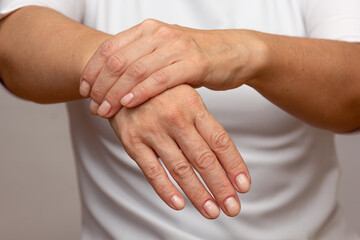 Woman hands showing right wrist pain over cropped body - obrazy, fototapety, plakaty