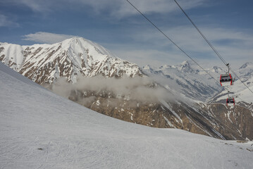 Fototapeta na wymiar Aerial drone view of Gudauri ski resort in winter. Caucasus mountains in Georgia. Kudebi, Bidara, Sadzele, Kobi aerial panorama in caucasus winter mountains.