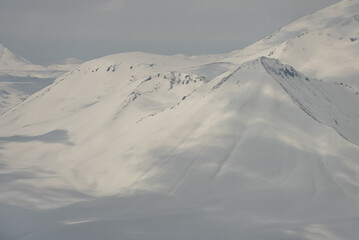 Fototapeta na wymiar Aerial drone view of Gudauri ski resort in winter. Caucasus mountains in Georgia. Kudebi, Bidara, Sadzele, Kobi aerial panorama in caucasus winter mountains.