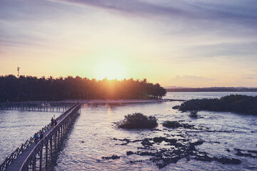 Naklejka premium Beautiful landscape. Sunset on the seashore. Wooden bridge on Cloud 9 beach, Siargao Island Philippines.