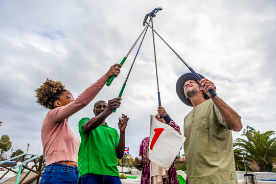Joyful friends celebrate at a mini golf course
