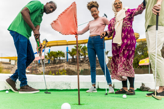 Enjoying a Round of Mini Golf Outdoors Together