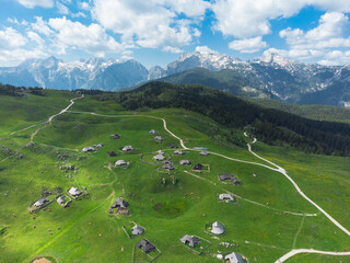 Aerial View of Mountain Cottages on Green Hill of Velika Planina Big Pasture Plateau, Alpine Meadow Landscape, Slovenia - 773971587