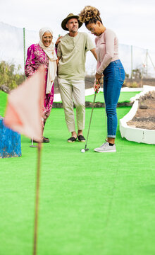 Diverse group enjoys mini golf outing together