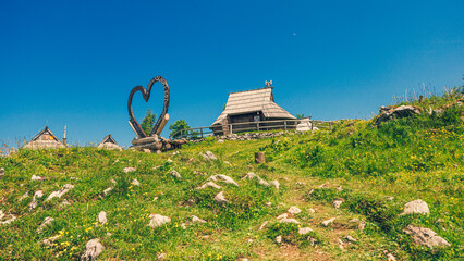 Traditional Mountain Wooden Shepherd Shelters on Big Pasture Plateau or Velika Planina in Slovenia - 773972526