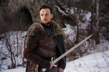 Prtrait medieval knight with sword in armor as style Game of Thrones in winter forest - 773975397