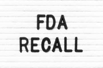 Black color letter in word FDA recall on white felt board background