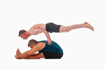 Paschimottanasana and Mayurasana, Ashtanga yoga  Side view of men wearing sportswear doing Yoga exercise against white background.