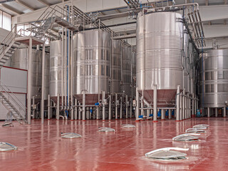 huge metal wine vats in wine cellar containers